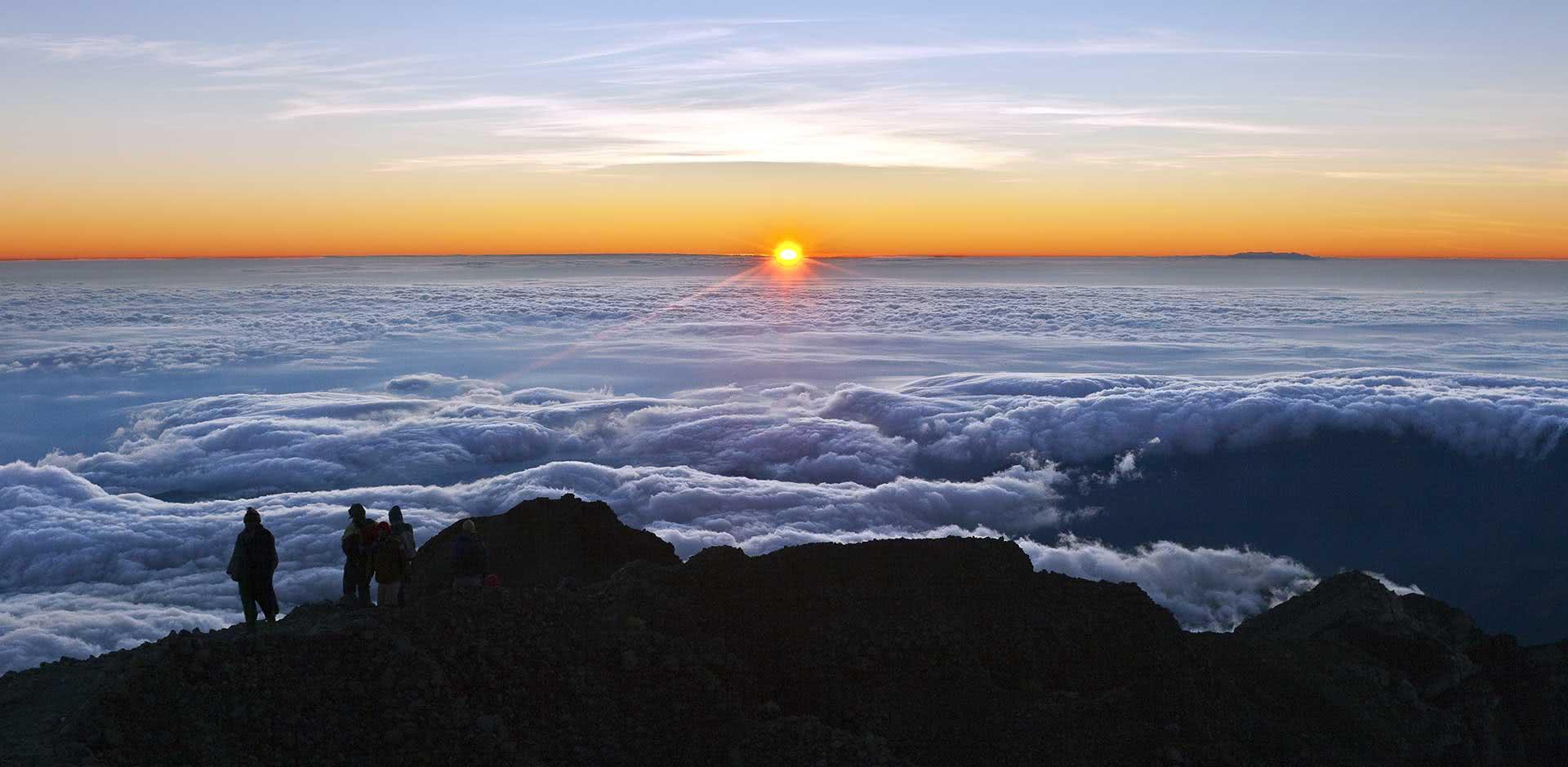 Panoramic view of the Rinjani ridge rising above the clouds