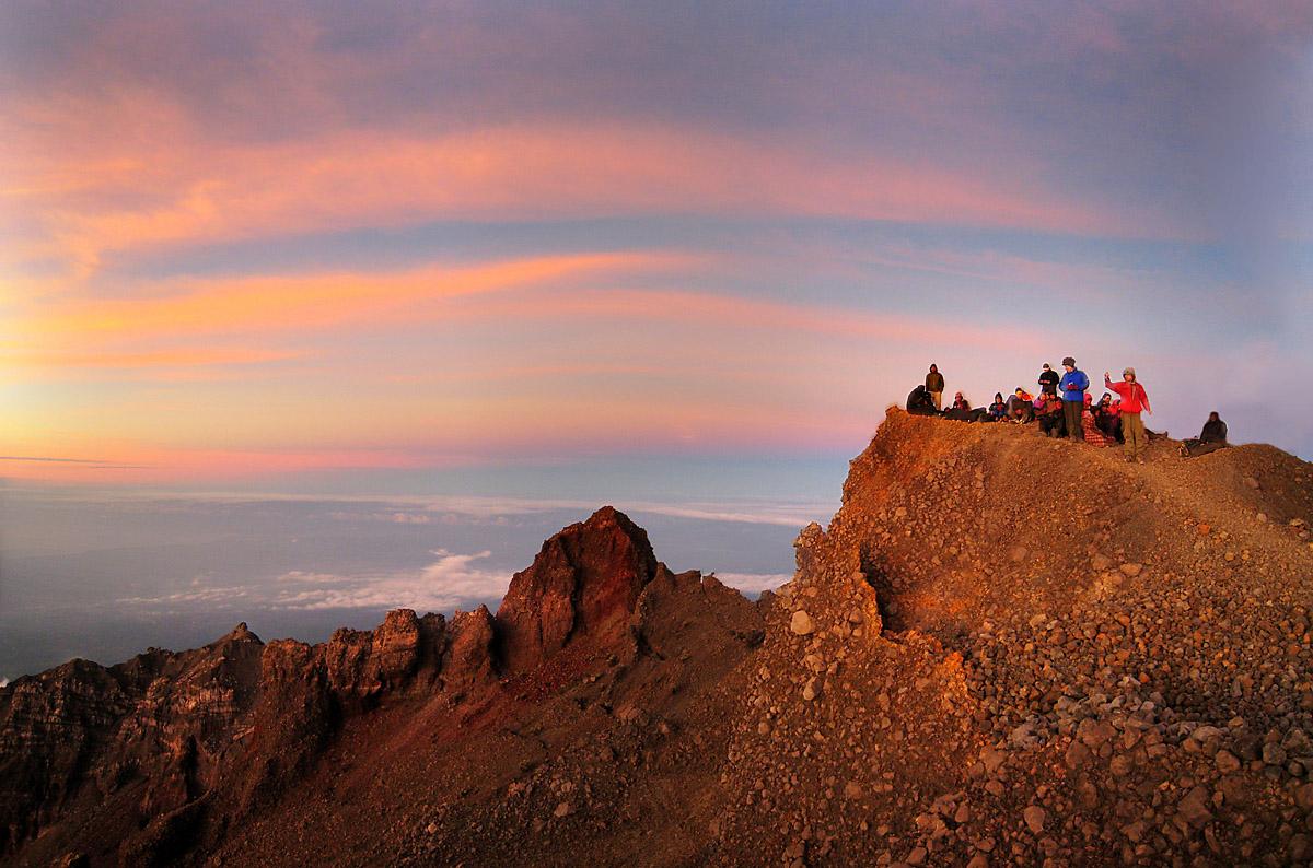 Trekkers on the summit attack trail toward the Rinjani peak at dawn