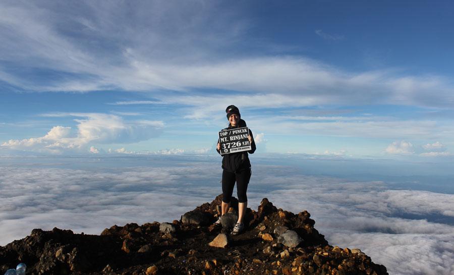 Trekker at the Mount Rinjani summit marker, 3,726 metres